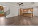 Open-concept living space with hardwood floors connecting the living room, staircase, and kitchen at 390 Pilot Ridge Rd, Zebulon, NC 27597