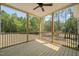 Covered porch features wood floors, a ceiling fan, and picturesque views of the surrounding landscape at 390 Pilot Ridge Rd, Zebulon, NC 27597