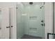 Modern shower with unique tile design, built-in shelves, and sleek fixtures, creating a spa-like experience at 390 Pilot Ridge Rd, Zebulon, NC 27597