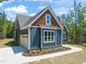 Exterior view of the home featuring a garage and beautiful landscaping at 390 Pilot Ridge Rd, Zebulon, NC 27597