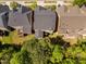 Aerial view showcasing the rear of homes featuring spacious green lawns and mature trees at 4121 Enfield Ridge Dr, Cary, NC 27519