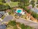 Gorgeous aerial view showcasing a sparkling pool and playground in a well-maintained neighborhood with mature trees at 4121 Enfield Ridge Dr, Cary, NC 27519