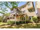 Exterior rear view of home featuring decks, patios, and lush greenery at 4121 Enfield Ridge Dr, Cary, NC 27519