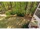 Beautifully landscaped backyard with lush greenery, mature trees, and natural light at 4121 Enfield Ridge Dr, Cary, NC 27519