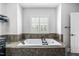 Bathroom with an oversized tub framed by large window with wooden shutters for privacy at 4121 Enfield Ridge Dr, Cary, NC 27519