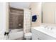 Bright bathroom features a tub with tile surround and a single sink vanity at 4121 Enfield Ridge Dr, Cary, NC 27519