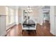 Bright dining room featuring a dark wood table, white chairs, hardwood floors, and elegant trim at 4121 Enfield Ridge Dr, Cary, NC 27519