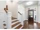 Elegant entryway with hardwood floors and a wooden staircase at 4121 Enfield Ridge Dr, Cary, NC 27519