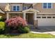 Charming two-story home with a manicured lawn and a stone-accented facade at 4121 Enfield Ridge Dr, Cary, NC 27519