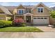 Charming two-story home with a manicured lawn and a stone-accented facade at 4121 Enfield Ridge Dr, Cary, NC 27519