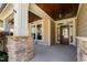 Charming covered front porch with wood ceiling and stone-based pillars at 4121 Enfield Ridge Dr, Cary, NC 27519