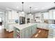 Spacious kitchen with white cabinets, stainless steel appliances, and a large center island at 4121 Enfield Ridge Dr, Cary, NC 27519