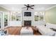 Cozy living room with fireplace, built-in shelves, hardwood floors, and comfortable seating at 4121 Enfield Ridge Dr, Cary, NC 27519