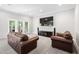 Bright living room with large TV, comfortable seating, and access to the porch at 4121 Enfield Ridge Dr, Cary, NC 27519