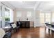 Bright living room with hardwood floors, large windows, and stylish furnishings at 4121 Enfield Ridge Dr, Cary, NC 27519