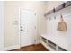 Well-organized mudroom with storage bench, hooks, and a shelf for bags at 4121 Enfield Ridge Dr, Cary, NC 27519