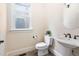 Charming powder room with a pedestal sink and a window at 4121 Enfield Ridge Dr, Cary, NC 27519