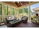 Comfortable screened porch with wood flooring and view of wooded backyard at 4121 Enfield Ridge Dr, Cary, NC 27519