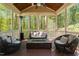 Relaxing screened porch with wicker seating, a fire pit, and a wooded view at 4121 Enfield Ridge Dr, Cary, NC 27519