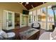 Cozy screened porch with fireplace table, modern seating, and a view into the living room at 4121 Enfield Ridge Dr, Cary, NC 27519