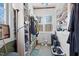 Bright closet space with built-in shelving, clothes racks and storage drawers, next to a large window for natural light at 4401 E L G Rd, Efland, NC 27243