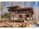 Charming rustic house with a wooden deck surrounded by trees, offering a serene and private setting at 4401 E L G Rd, Efland, NC 27243