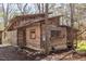 Charming log cabin with rustic details and beautiful woodwork, surrounded by a serene natural setting and stone landscaping at 4401 E L G Rd, Efland, NC 27243
