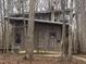 Charming wood house surrounded by trees, showcasing natural beauty and tranquility at 4401 E L G Rd, Efland, NC 27243