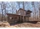 Rustic home featuring a screened porch and natural wood siding, nestled among mature trees at 4401 E L G Rd, Efland, NC 27243