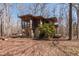 Rustic house with a screened-in porch offering a peaceful retreat surrounded by nature at 4401 E L G Rd, Efland, NC 27243
