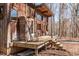 Inviting wooden deck with rocking chair and seating, perfect for relaxing in a tranquil setting at 4401 E L G Rd, Efland, NC 27243