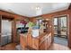 The kitchen offers rustic charm with its wood walls, hanging pots, and easy access to the deck at 4401 E L G Rd, Efland, NC 27243