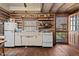 Rustic kitchen with vintage appliances, log walls, and wooden floors, offering a cozy, country-style living experience at 4401 E L G Rd, Efland, NC 27243