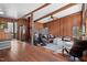 Open living area with wood walls, hardwood flooring, comfortable seating, and natural light at 4401 E L G Rd, Efland, NC 27243