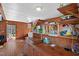Open-concept living room with wood walls and floors, and access to a deck at 4401 E L G Rd, Efland, NC 27243