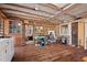 Charming rustic living space with log walls, exposed beams, and wood flooring, offering a unique country aesthetic at 4401 E L G Rd, Efland, NC 27243