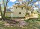 Expansive backyard featuring a wooden deck, brick patio, lush lawn, and mature trees, perfect for entertaining at 4508 Fox Rd, Raleigh, NC 27616