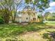 Large backyard featuring a wooden deck, patio, and mature trees, providing privacy and a relaxing outdoor retreat at 4508 Fox Rd, Raleigh, NC 27616
