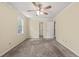 Simple bedroom with a ceiling fan, closet, and a view to another room at 4508 Fox Rd, Raleigh, NC 27616