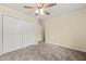 Neutral bedroom with carpeted floors, ceiling fan, and closet with ample storage space at 4508 Fox Rd, Raleigh, NC 27616