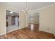 Bright dining room with hardwood floors offering views into the kitchen and living areas at 4508 Fox Rd, Raleigh, NC 27616