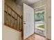 Inviting entryway with hardwood floors, staircase, and a view to the front yard through an open door at 4508 Fox Rd, Raleigh, NC 27616