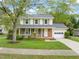 Charming two-story home with brick facade, green shutters, a front porch, and attached garage at 4508 Fox Rd, Raleigh, NC 27616