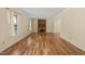 Spacious living room featuring hardwood floors, a brick fireplace, and abundant natural light at 4508 Fox Rd, Raleigh, NC 27616