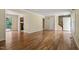 Open-concept living room with hardwood floors, access to deck and kitchen, and staircase visible at 4508 Fox Rd, Raleigh, NC 27616