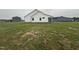 View of the home's rear exterior shows white siding and back porch at 47 Silver Ct, Smithfield, NC 27577