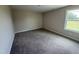 Carpeted bedroom offering a bright window, neutral walls, and ample space for furniture at 47 Silver Ct, Smithfield, NC 27577