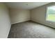 Cozy bedroom with plush carpet, a neutral color scheme, and a large window at 47 Silver Ct, Smithfield, NC 27577