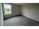 A basic bedroom with carpet, a neutral color scheme, and a window at 47 Silver Ct, Smithfield, NC 27577
