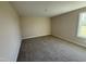 A simple bedroom with carpet and a window, providing natural light at 47 Silver Ct, Smithfield, NC 27577